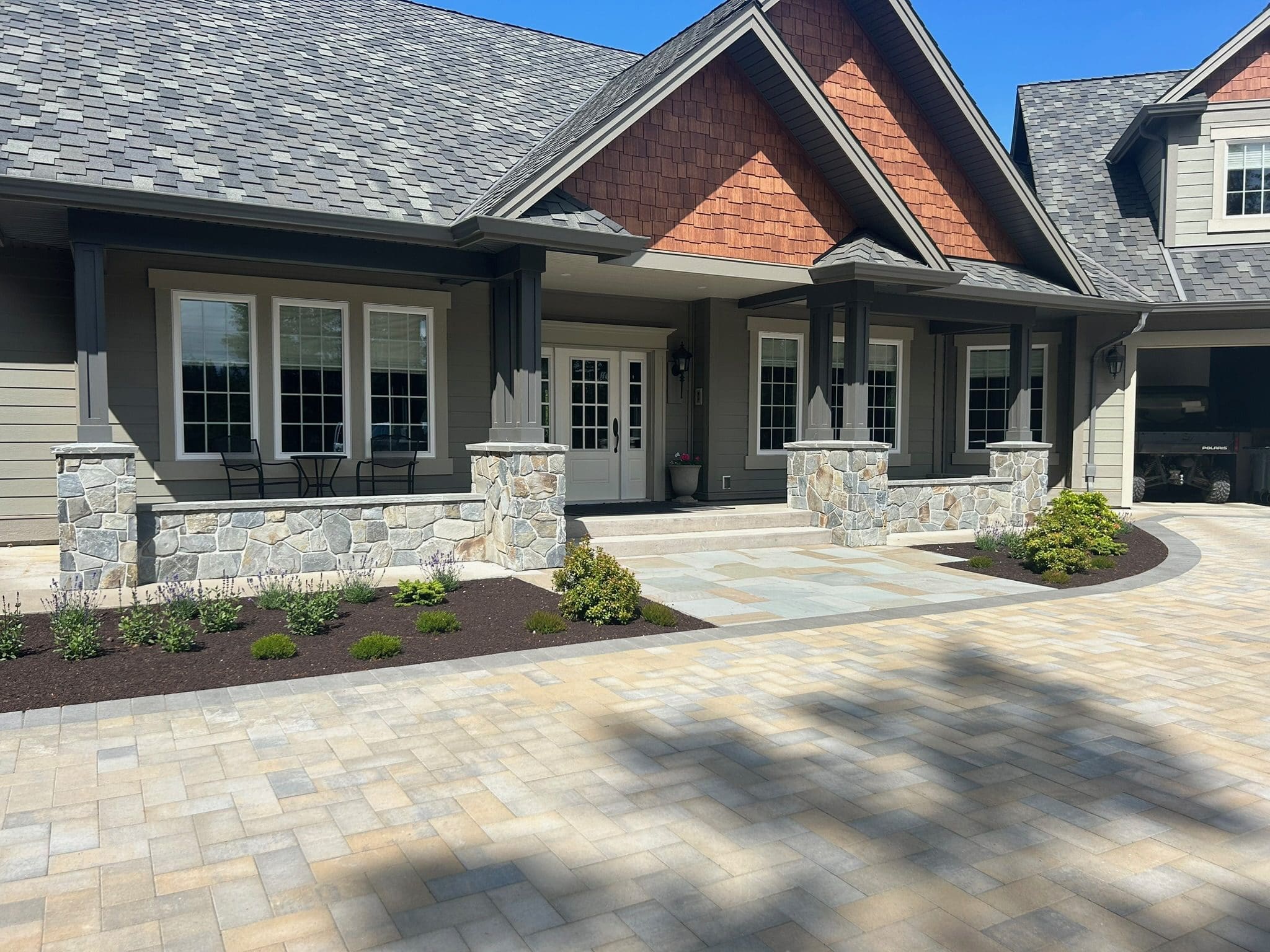 Completed stone posts and wall on a custom home in the Comox Valley, by Central Masonry