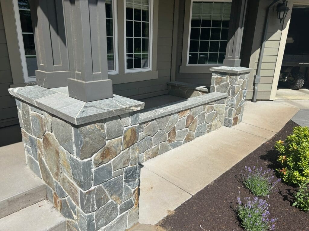 Detail of custom stone columns and natural veneer masonry on a front porch in Courtenay BC, completed by Central Masonry