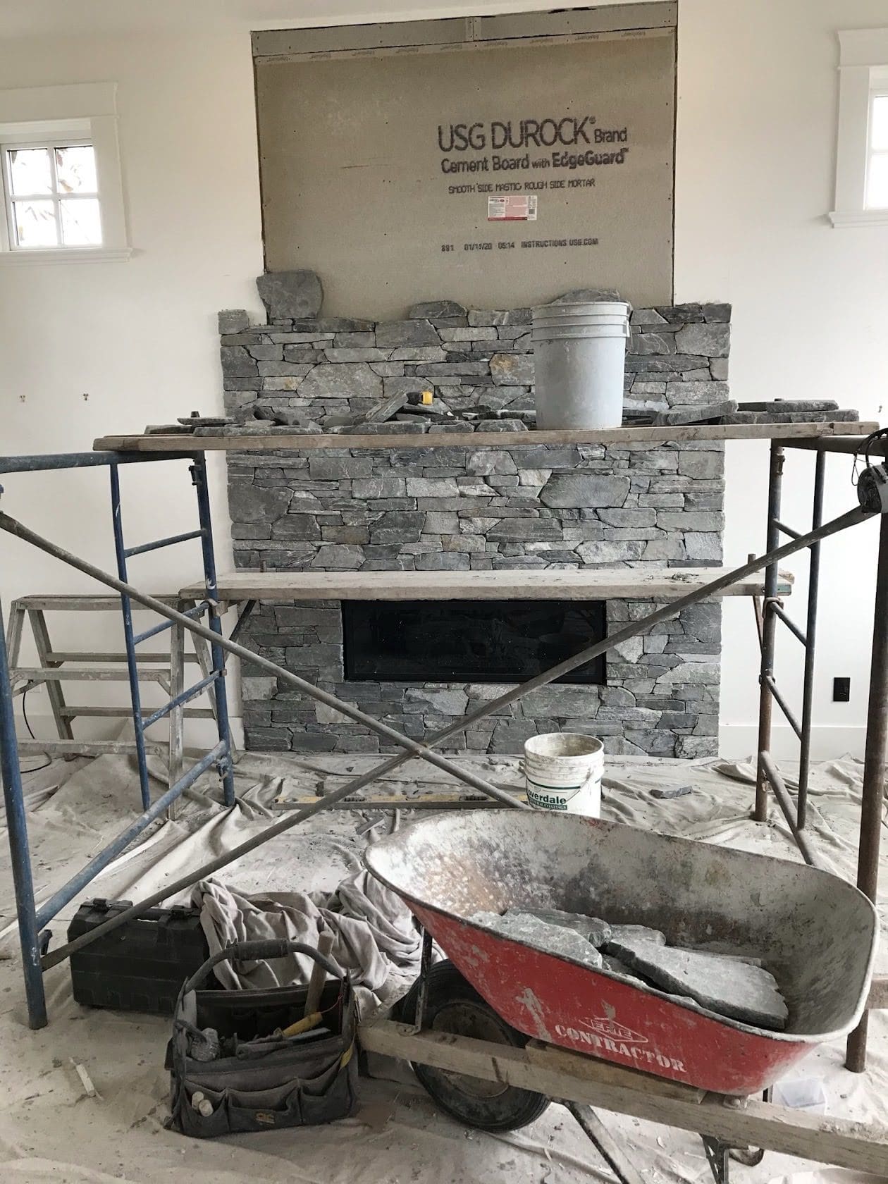 Stone fireplace under construction by Central Masonry, showcasing quality craftsmanship and attention to detail during installation