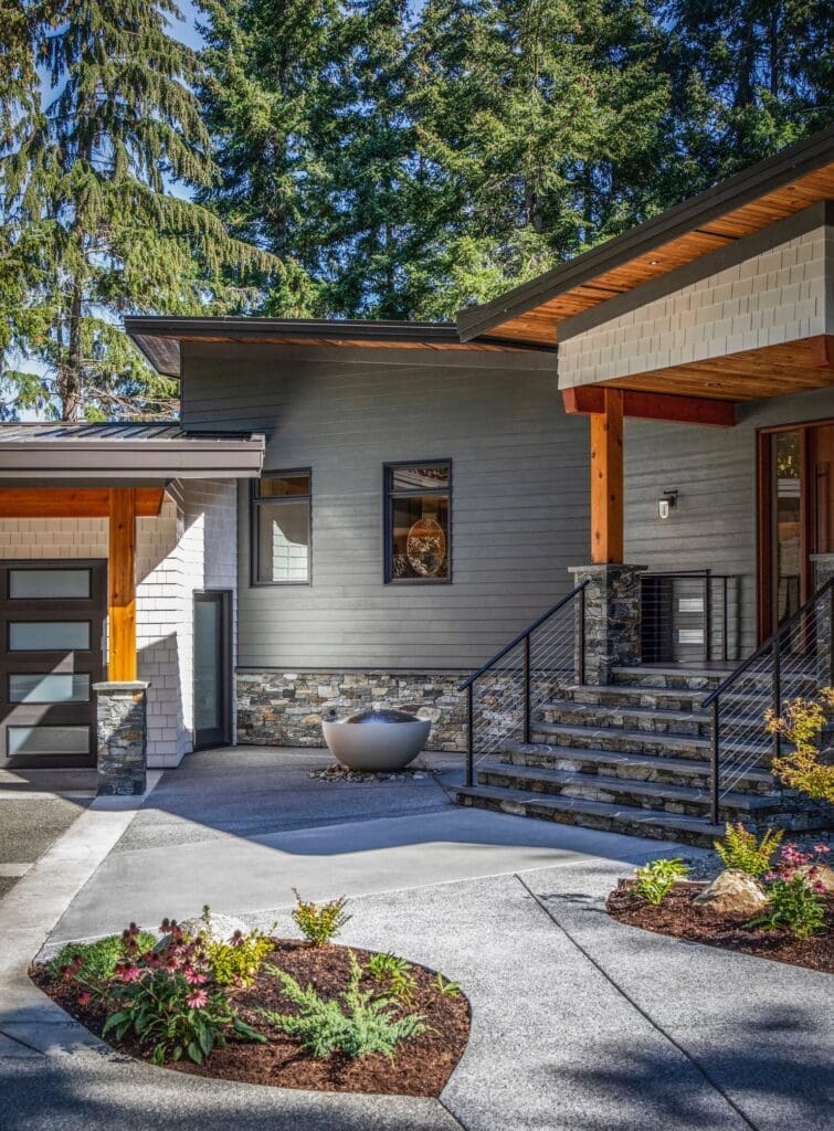 Stone exterior facing, entry steps, and columns on a modern home in Courtenay BC, completed by Central Masonry