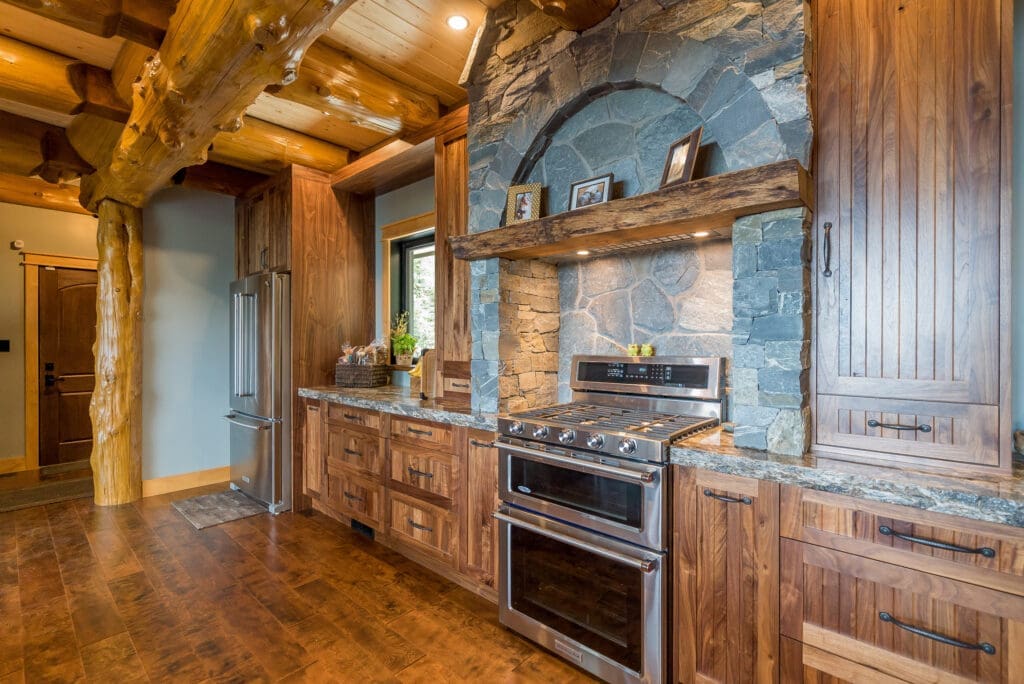 Custom stone kitchen feature wall and archway, using K2 Stone, in a log home built by Facet Builders - Comox Valley BC